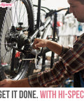 Person repairing a bicycle in a workshop with Hi-Spec tools.