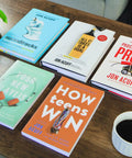 Fresh Start Blueprint A Straight Fire Guide To Level Up Your Life Mindset And Crush Major Changes In This Rock Solid Self Help Manual For Determined Go Getters Ready on a wooden table with glasses and a coffee cup.