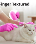 Person using Top Tier Disposable Nitrile Gloves In Bright Fuchsia, Powder Free Latex Free, 3 Mil grooming a white cat.