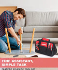 Man assembling furniture with All In One 215 Piece Home Repair Tool Set With 12 Inch Wide Mouth Storage Bag A Real Workhorse For DIY Projects Heavy Duty Household Hand Tool Kit Red visible.