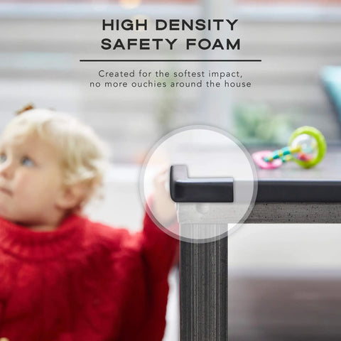 Tot Friendly Corner And Edge Guard Protector Set Includes Sixteen Pre Taped Furniture Bumpers For Tables And Counters Brown protecting table corner with toddler in background.
