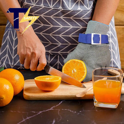 Person using Level 9 ANSI A9 Beefy Cut Resistant Gloves With Stainless Steel Mesh And Metal Wire Construction For Meat Processing And Food Prep Heavy Duty Rustproof Hand Protection Medium Size to slice an orange.