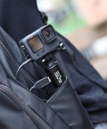 10000mAh Battery Handle Grip For DSLR Action Camera And Smartphone Rig in backpack pocket, connected with cable.