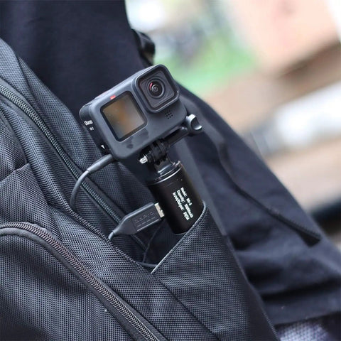 10000mAh Battery Handle Grip For DSLR Action Camera And Smartphone Rig in backpack pocket, connected with cable.