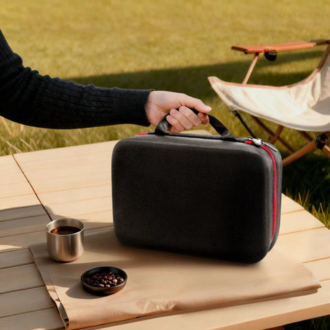 Slick Waterproof Coffee Grinder Travel Case Hella Rugged Shockproof Portable Storage Pouch held with a grab handle on a table.