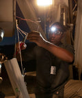 Man using Remix LED Headlamp With 300 Lumens Multicam Camouflage Red Green And Blue LEDs And White Spotlight for night work
