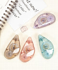 4 Pack Double Sided Tape Roller Set For Crafts And Scrapbooking With Built In Roller Heads on a notebook background