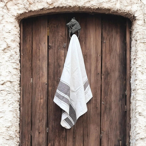 Handcrafted Cast Iron Horsehead Wall Hook With A Knockout Rustic Coffee Bean Brown Finish Built Like A Tank For Hanging Coats Keys Hats And Gear Includes Hardware, holding a towel on a wooden door.
