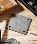 Eight Piece Five By Five Inch A36 Steel Plates One Quarter Inch Thick With Four Holes on workbench with tools around