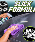 Swift Wipe Waterless Car Wash Spray With High Lubrication Formula, 1 gallon bottle sprayed on a car hood and wiped with a purple microfiber towel