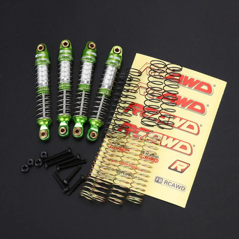 Lengthened Fifty Nine Millimeter Aluminum Oil Filled RC Shock Absorber Upgrade With Three Spring Options Ten Percent Softer Twenty Percent Softer And Twenty Percent Stiffer For Traxxas Defender And Bronco Eighteen Scale Front And Rear Shocks Green with accessories on display