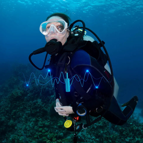 Scuba diver using Underwater Signal Rattle Stick For Scuba Diving With Clip, Loud Audible Alert From Steel Balls, in ocean.