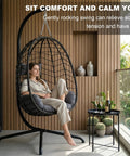 Woman relaxing in Hanging Egg Chair With Stand For Indoor And Outdoor Relaxation Cozy Wicker Hammock Lounge Chair with cushion on balcony.