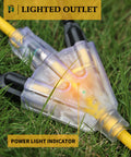 Heavy Duty 25 Ft Outdoor Extension Cord With Three Outlets Waterproof 12 Gauge 3 Prong SJTW Cable Lighted End 15 Amp 1875 Watt ETL Listed Go To Garage Garden And Home Durable Rugged Yard Power Cord Yellow with lighted ends shown in grass
