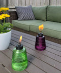 Carnival Glass Tabletop Torches 3 Pack for Patio Backyard and Garden Lighting Portable Glass Flame Torches in Blue and Purple on patio table