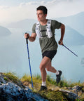 Man hiking with Go-To 5L Hydration Vest for Running and Cycling with Dual 500ml Soft Flasks, Lightweight Water Backpack on mountain trail