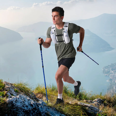 Man hiking with Go-To 5L Hydration Vest for Running and Cycling with Dual 500ml Soft Flasks, Lightweight Water Backpack on mountain trail