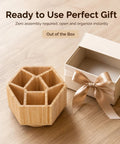 360 Degree Rotating Bamboo Desk Organizer With Hexagonal Compartments next to an open gift box on wooden surface
