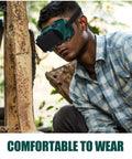 Industrial Grade Welding Goggles With Dual Flip Up Covers That Sit Hella Comfy Featuring An Adjustable Contour Strap Heavy Duty Impact Resistant Dust Proof Safety Specs Built Tough For Daily Grind worn by a person during work.