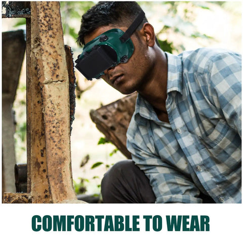 Industrial Grade Welding Goggles With Dual Flip Up Covers That Sit Hella Comfy Featuring An Adjustable Contour Strap Heavy Duty Impact Resistant Dust Proof Safety Specs Built Tough For Daily Grind worn by a person during work.