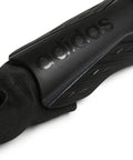 Close-up of black shin guard with ankle sleeve, logo detail of Soft Ground Soccer Shin Guards With Pro Grade EVA Shield Quick Adjust Single Strap Ankle Protection Fearless Defense On The Pitch Large Black White Iron Metallic Durable Shielding For Tough Games