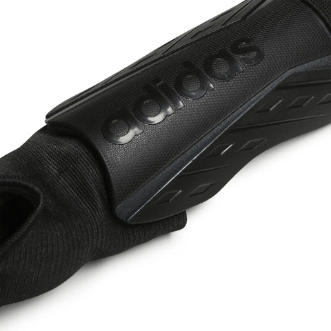 Close-up of black shin guard with ankle sleeve, logo detail of Soft Ground Soccer Shin Guards With Pro Grade EVA Shield Quick Adjust Single Strap Ankle Protection Fearless Defense On The Pitch Large Black White Iron Metallic Durable Shielding For Tough Games