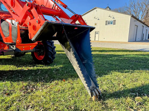 Stump Bucket For Tractors And Skid Steers Up To 105 HP With Bi Directional Ripping Edge attached to tractor, close-up view