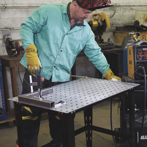 Man using 4 Piece Welding Table Clamp Kit With Lightweight Aluminum Frame And ABS Handle, Easy Setup for secure hold on 16mm hole table