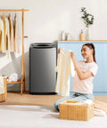 Comfee portable washing machine, 0.9 cu ft gray top-load compact washer in laundry room with woman loading clothes