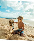 A child and a dog play on a sunny beach, capturing a moment of bonding with waves and blue skies in the background.