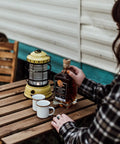 Dusty Yellow Forest Lantern Vintage Rechargeable Led Lantern With Adjustable Brightness Battery Operated Camping Light placed on wooden table.