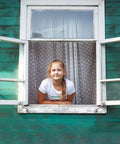 Hook-and-eye window latch on green wooden wall; silver hardware, open window with girl leaning out.