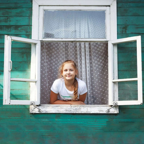 Hook-and-eye window latch on green wooden wall; silver hardware, open window with girl leaning out.
