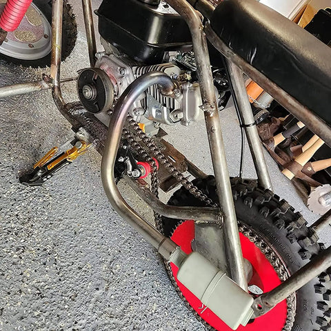 Installed Beefy Heavy Duty Exhaust With Muffler For Predator 212cc 6.5 HP Honda GX160 GX200 on go-kart frame in garage.
