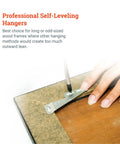 Close-up of a hand installing Rock Solid Self Leveling Sawtooth Picture Frame Wall Hangers for Wood Art Displays using a screwdriver.
