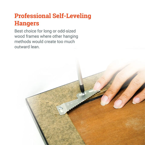 Close-up of a hand installing Rock Solid Self Leveling Sawtooth Picture Frame Wall Hangers for Wood Art Displays using a screwdriver.