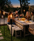 Friends enjoying evening talks on patio with 55 Inch Outdoor Oil Torch Lamps Four Pack Rustproof Stainless Steel Citronella Torches.