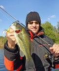 Dope 15 Piece Fishing Jig Heads With Spinner Hooks In Vibrant Mixed Hues Perfect For Crappie And Runner Bass Includes Solid Plastic Tackle Case 1/8 Oz Freshwater Tackle Kit, angler holding bass fish.