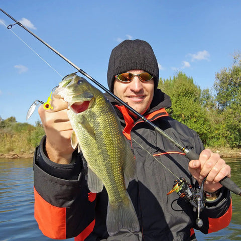 Dope 15 Piece Fishing Jig Heads With Spinner Hooks In Vibrant Mixed Hues Perfect For Crappie And Runner Bass Includes Solid Plastic Tackle Case 1/8 Oz Freshwater Tackle Kit, angler holding bass fish.