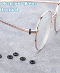Glasses Repair Kit With Hinge Tighteners, Frame Grips And Silicone Rings shown with eyeglasses and silicone rings on table