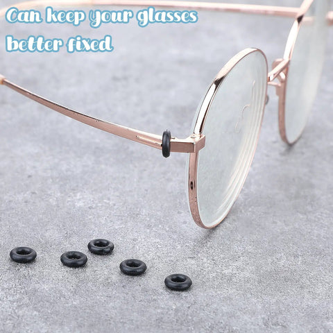 Glasses Repair Kit With Hinge Tighteners, Frame Grips And Silicone Rings shown with eyeglasses and silicone rings on table