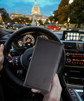Slick Carbon Fiber Black Car Registration And Insurance Card Holder With Fast Flip Clear Window showcased in a car interior.