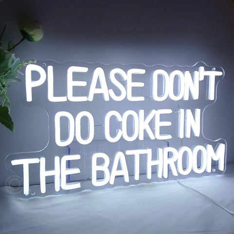 White neon sign on acrylic reads "Please Don't Do Coke In The Bathroom"
