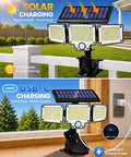 Super Bright Clip On Solar Outdoor Flood Light With Smart Motion Sensor And USB C Recharging Heavy Duty Clamp on a railing near a garden.