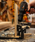 Using a pocket hole jig kit for woodworking with metal body to drill into wood, featuring an adjustable clamp and heavy-duty aluminum base.
