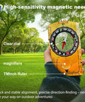 Person holding 4 Pack Waterproof Adjustable Declination Orienteering Compass With Magnifier And Ruler in a green park setting.
