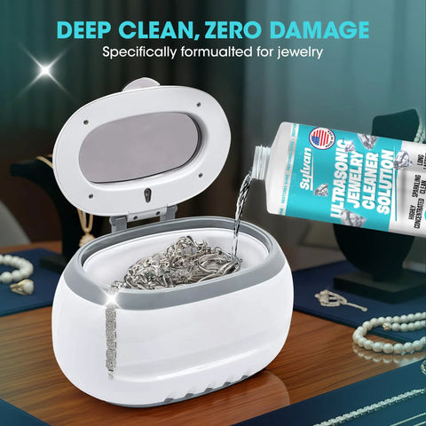 Ultra Strong 32 Oz Ultrasonic Jewelry Cleaner Solution pouring into cleaner with silver jewelry inside on a table.