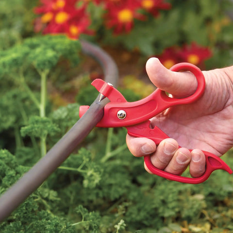 Drip Tubing Cutter And Punch Gun Kit for 1 inch flexible tubing cutting Blu-Lock pipe in garden setting with red handle