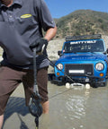 XRC Gen 2 9500lb Winch With Steel Cable For Heavy Duty Off Road Recovery 6.6HP Motor 12 Inch Remote Lead 93.5 Inch Wire Rope 3 Stage Gear Train Rugged All Terrain Beast For Jeeps And Trucks, steel cable being used to recover a Jeep in water