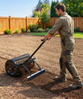 Man using Walk Behind Or Towable Compost Spreader with 24 inch spreading width on soil, adjustable push handle, in garden setting